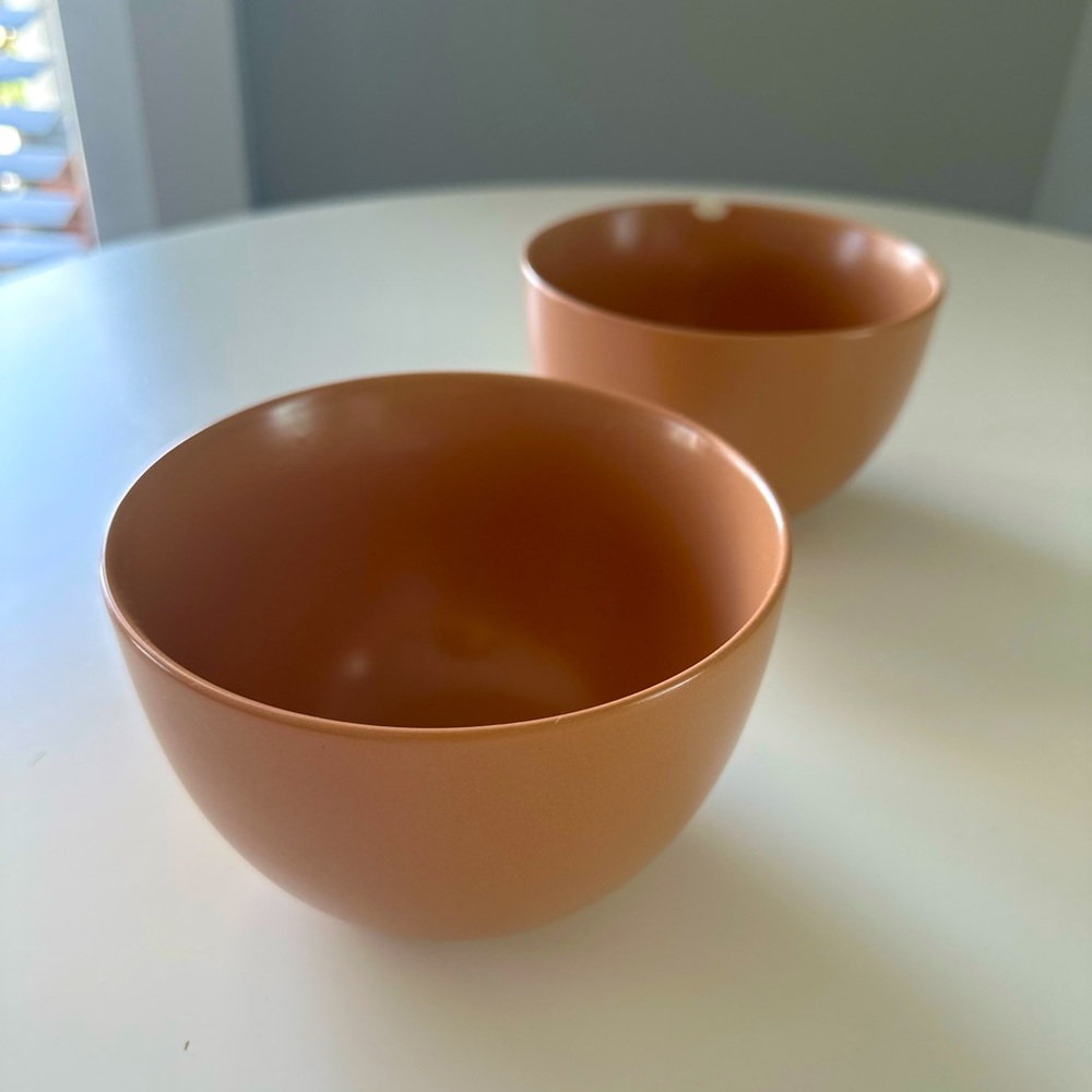 Two perfectly sized cereal bowls in a matte peach color